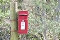 Red post box in Scottish rural location in countryside by Loch Tay Royalty Free Stock Photo