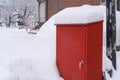 Red post box with snow cover in on the street at Japan Royalty Free Stock Photo