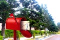 Red postal box on walkway Royalty Free Stock Photo