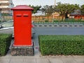 Red postbox on footpath in Thailand