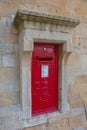 Red postbox on the stone wall at Windsor Castle, England Royalty Free Stock Photo