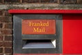 A red postbox with the words franked mail above it Royalty Free Stock Photo