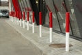 Red posts in the parking lot. Car traffic limiters
