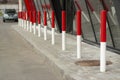 Red posts in the parking lot. Car traffic limiters