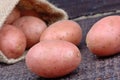 Red potatoes in a jute sack on table Royalty Free Stock Photo