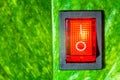 Red power switch on green leaves save World concept friendly ene Royalty Free Stock Photo