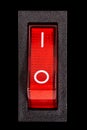 Red power switch at ON position, isolated on black background Royalty Free Stock Photo