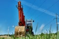 A red powerful crawler excavator standing on a grassy area. Rent, rent for earthworks.