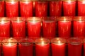 Red prayer candles burning inside a church Royalty Free Stock Photo