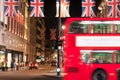 London flags and london bus by night