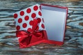 Red present box with knot on vintage wooden board Royalty Free Stock Photo