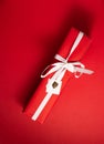 Red present or gift for valentines or christmas on a red background