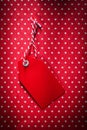 Red pricetag on polka-dot background