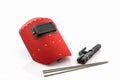 Red protective screen and rod-holder with Welding electrodes wire, for electric arc welding. Royalty Free Stock Photo