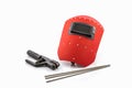 Red protective screen and rod-holder with Welding electrodes wire. Royalty Free Stock Photo