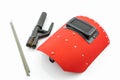 Red protective screen and rod-holder with Welding electrodes wire, for electric arc welding. Royalty Free Stock Photo