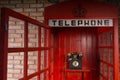 Red Public Telephone Booth with Open Door Royalty Free Stock Photo