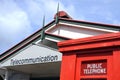 Red public telephone outside Telecommunication centre