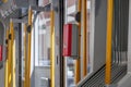 Red public transportation ticket stamp or validation ticket machine in front of automatic door of light rail tram Royalty Free Stock Photo