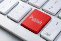 Red Publish Button on a White Keyboard A Striking Visual for Digital Content Management Social Media Posting or Royalty Free Stock Photo