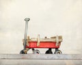 Red pull trolley toys, old rusty wagon, Vintage color tone on pastel style
