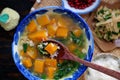 Red pumpkin with peanut soup bowl for vegan meal, Vietnamese vegetarian dish