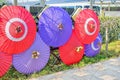 Red and purple oiled paper umbrellas with beautiful decorations