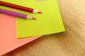 Blank yellow and pink sticky notes/post it and two color pencils Royalty Free Stock Photo