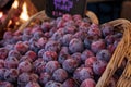 Red purple pluots also called plumbs in a basket sold at a farmers market