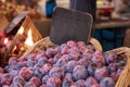 Red purple pluots also called plumbs in a basket sold at a farmers market Royalty Free Stock Photo