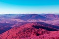 Red purple surreal mountain landscape at the background of azure sky, the concept is amazing and fantastic world