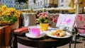 Street Cafe Tables chairs with cup of coffee Flowers City lifestyle Summer Day In Old Town Of Tallinn travel and tourism To Est