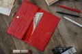 Red purse clutch purse, woman accessories and money on a white wooden table