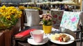 Street Cafe Tables chairs with cup of coffee Flowers City lifestyle Summer Day In Old Town Of Tallinn travel and tourism To Est