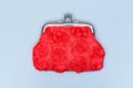 Red purse on a grey background. Red wallet for coins