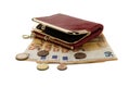 A red purse lying on fifty euro notes and coins, isolated Royalty Free Stock Photo