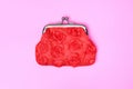 Red purse on a pink background. Red wallet for coins