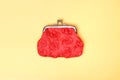 Red purse on a yellow background. Red wallet for coins