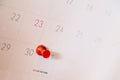 Red push pin on calendar page for remind and marked important events day,red pin in a calender on important date Royalty Free Stock Photo