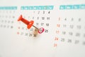 Red push pin marked on 24th date on white calendar with red circle Royalty Free Stock Photo