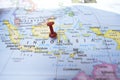 Red Push Pin Pointing Indonesia on Location of World Map Close-Up View