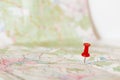 Red pushpin marking a location on an open map Royalty Free Stock Photo