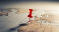 A red pushpin marking a specific location on a detailed world ma Royalty Free Stock Photo