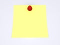 Red pushpin and yellow note