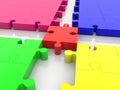 Red puzzle piece as a junction between puzzle pieces of different colors Royalty Free Stock Photo