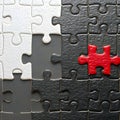 red puzzle piece fitted into monochrome puzzle background Royalty Free Stock Photo