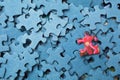 Red puzzle piece on top of blue pieces Royalty Free Stock Photo