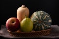 Red apple, pear and butternut squash in basket Royalty Free Stock Photo