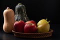 Red apple, pear and butternut squash on black background Royalty Free Stock Photo