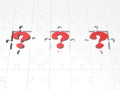Red question marks between white pieces of a puzzle Royalty Free Stock Photo